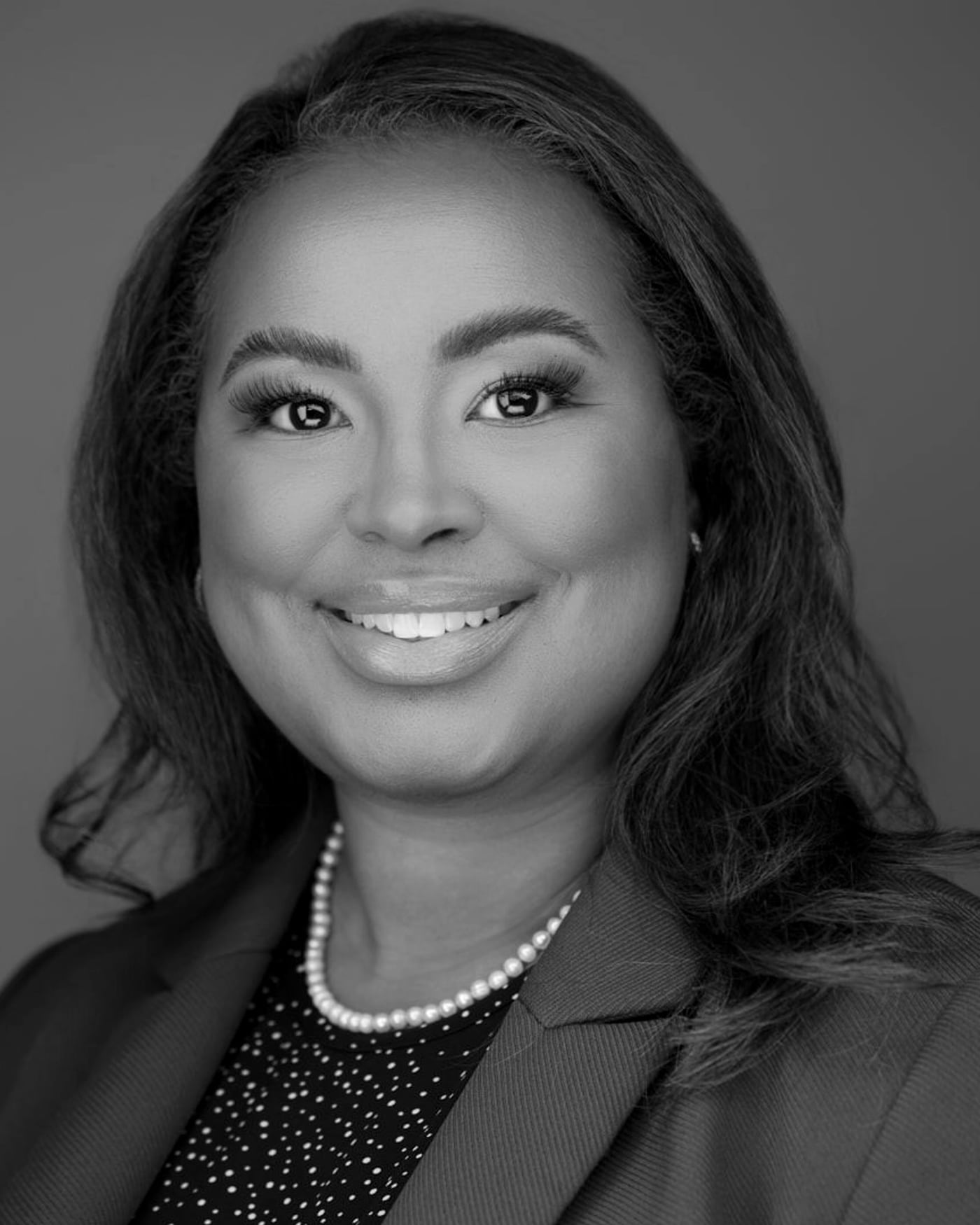 Black-and-white fine-art portrait of a woman with long hair and a tailored blazer.